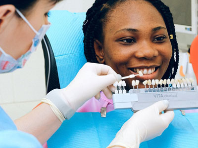 Dentist examining patient’s teeth in Houston dental clinic